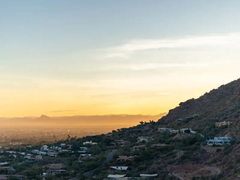 Phoenix at golden hour, the city spreading out below Camelback Mountain