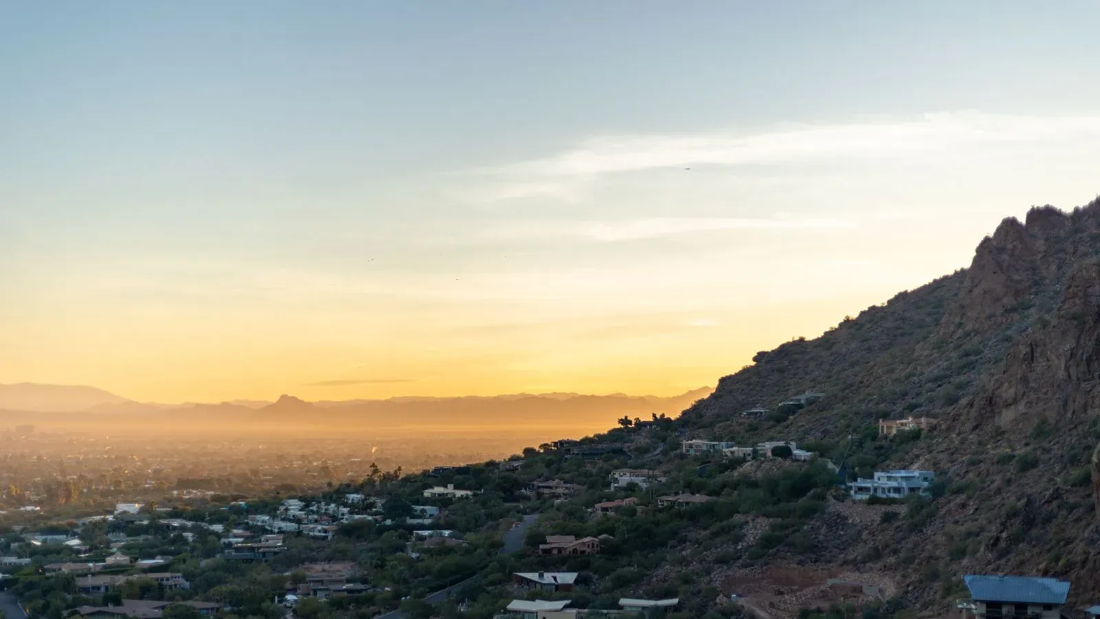 Phoenix at golden hour, the city spreading out below Camelback Mountain