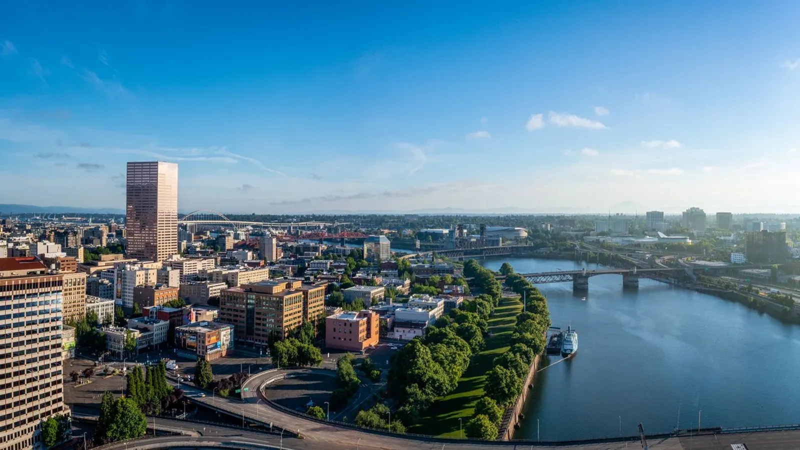 Downtown Portland from the air, the Willamette River and its bridges crossing the frame