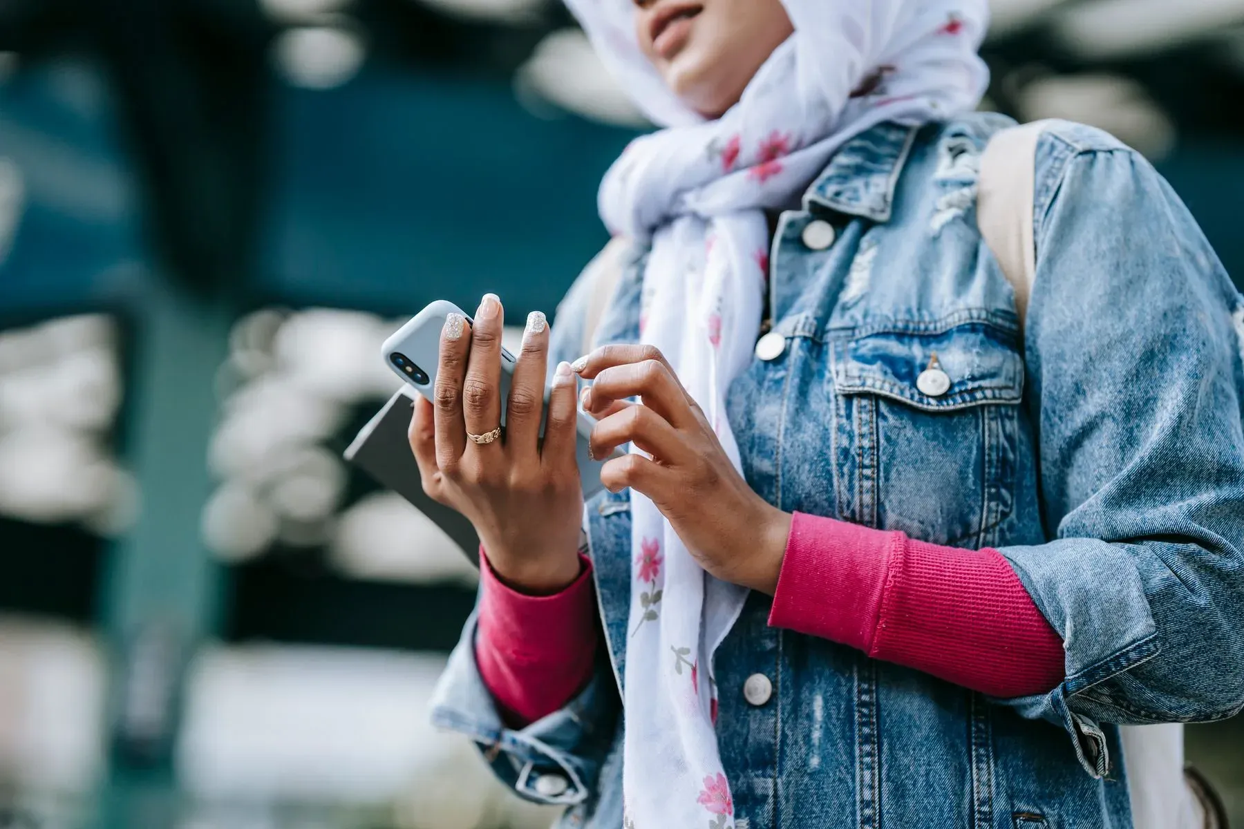 A person searching on their phone on a city street, the way most patients start looking for care
